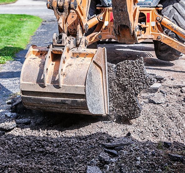 a bulldozer is digging a hole in the ground .