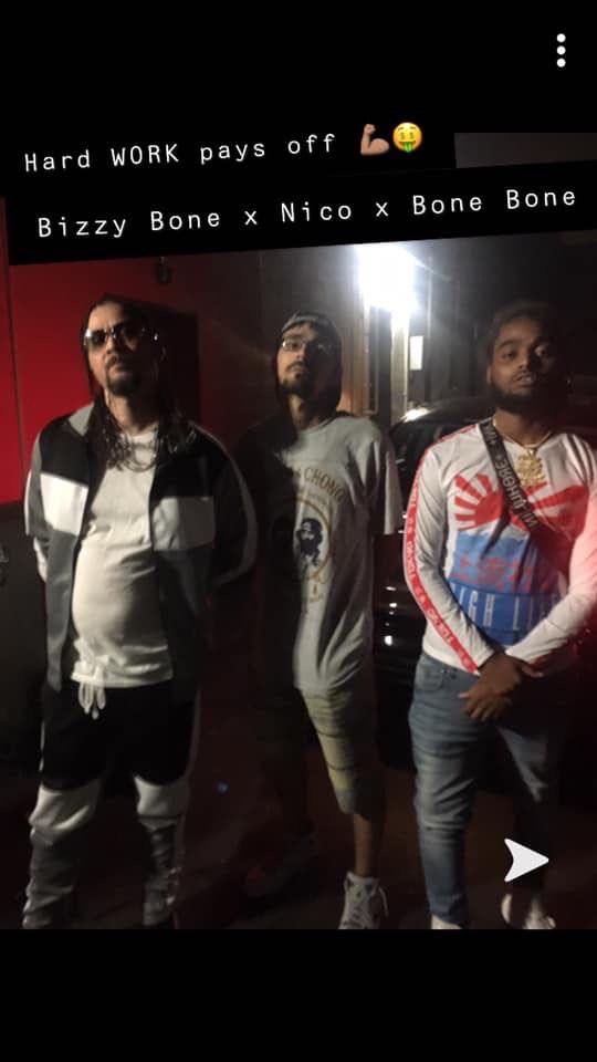 A group of men are standing next to each other in a dark room.