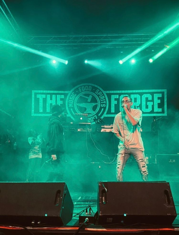 A man is standing on a stage holding a microphone.