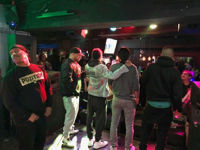 A group of people are standing in a dark room.