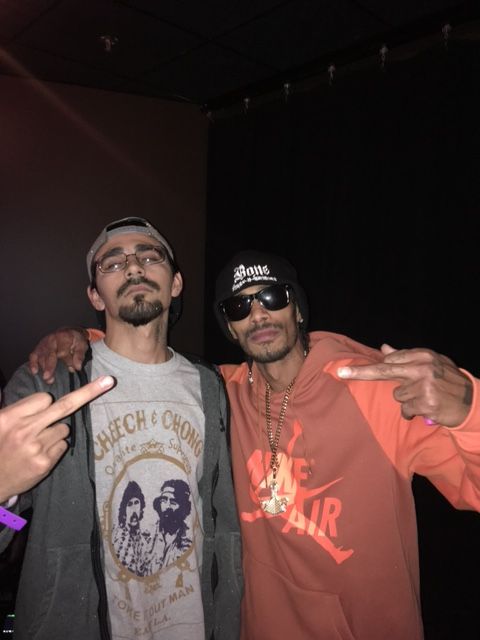 Two men are posing for a picture and one is wearing a shirt that says che guevara