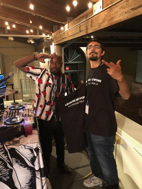 Two men standing next to each other with one holding a shirt that says ' abercrombie & fitch ' on it