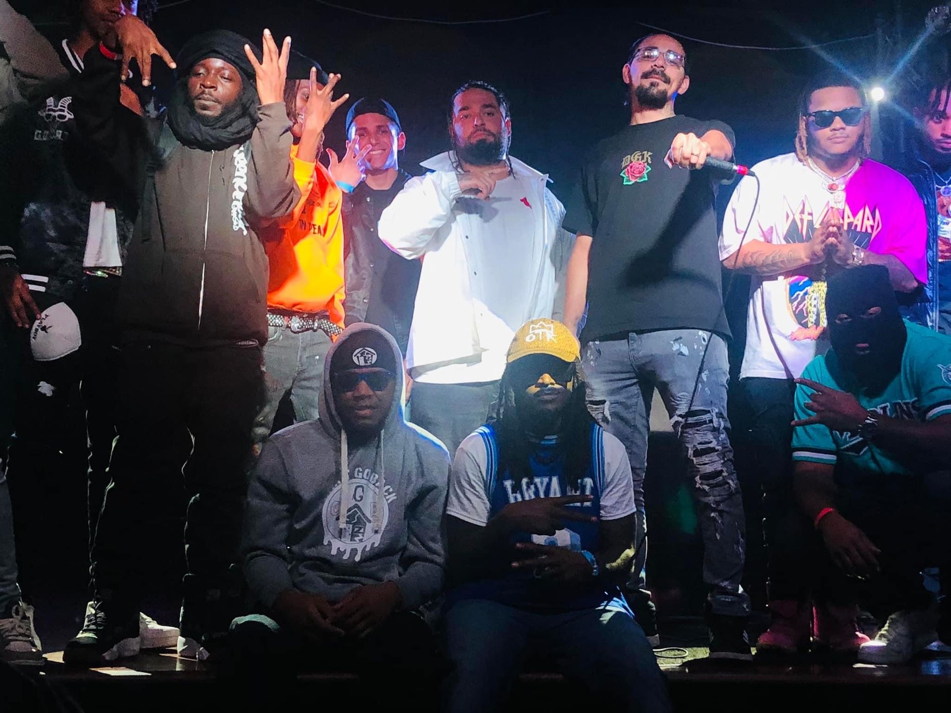 A group of men are posing for a picture on a stage.