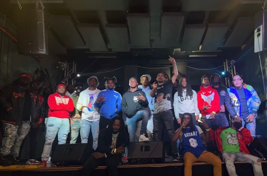 A group of people are posing for a picture on a stage.