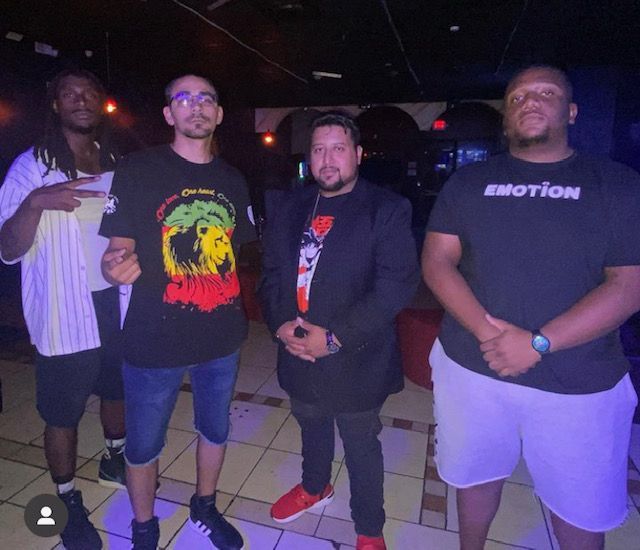 A group of men are posing for a picture and one of them is wearing an emotion shirt