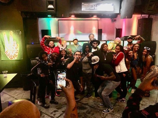 A group of people are posing for a picture in a room.