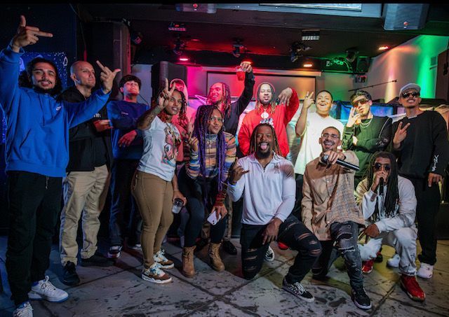 A group of people are posing for a picture in a club.