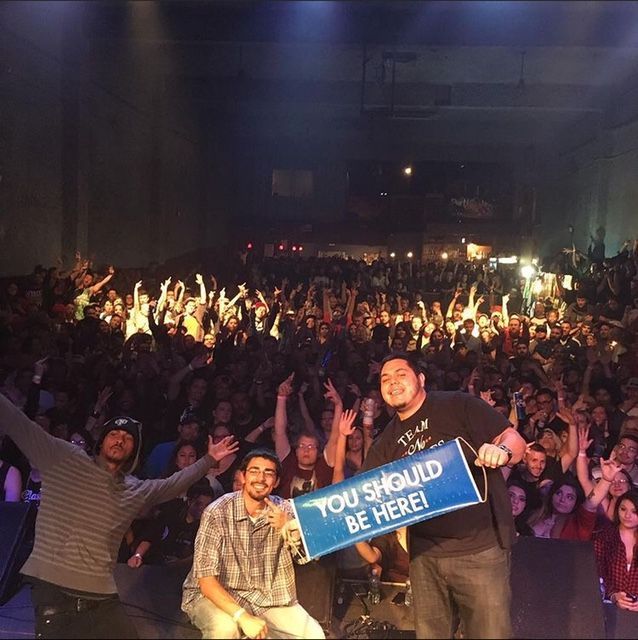A man holding a sign that says you should be here