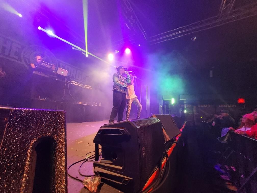 A couple standing on a stage with a microphone in front of them