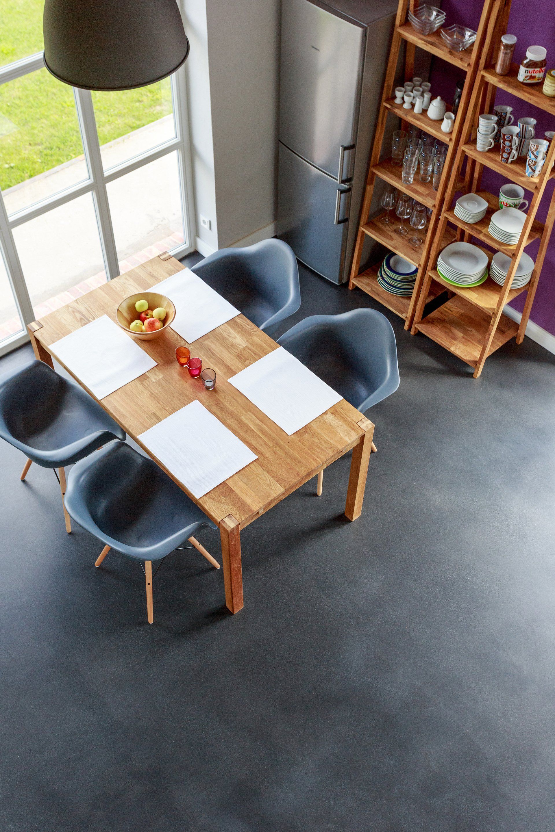Dark grey resin floors in restaurant with table and chairs