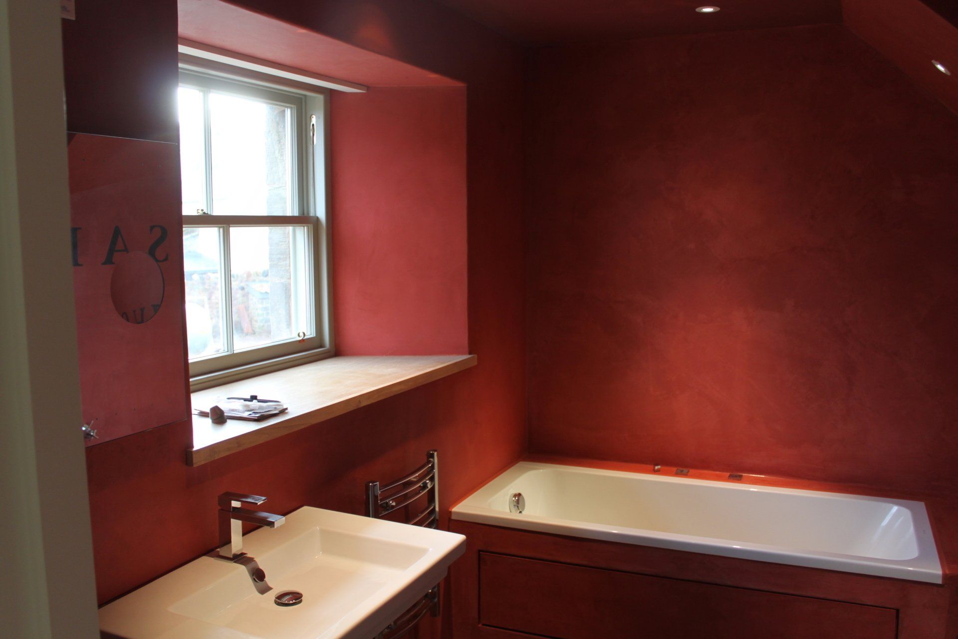 Red resin feature wall in bathroom