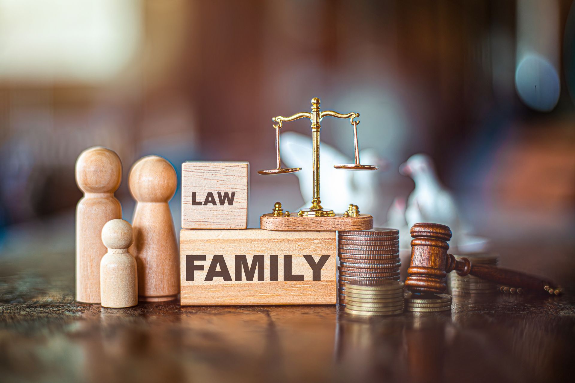 Wooden blocks with “Family Law” and a scale of justice on a table. Wooden blocks with “Family Law” and a scale of justice on a table.
