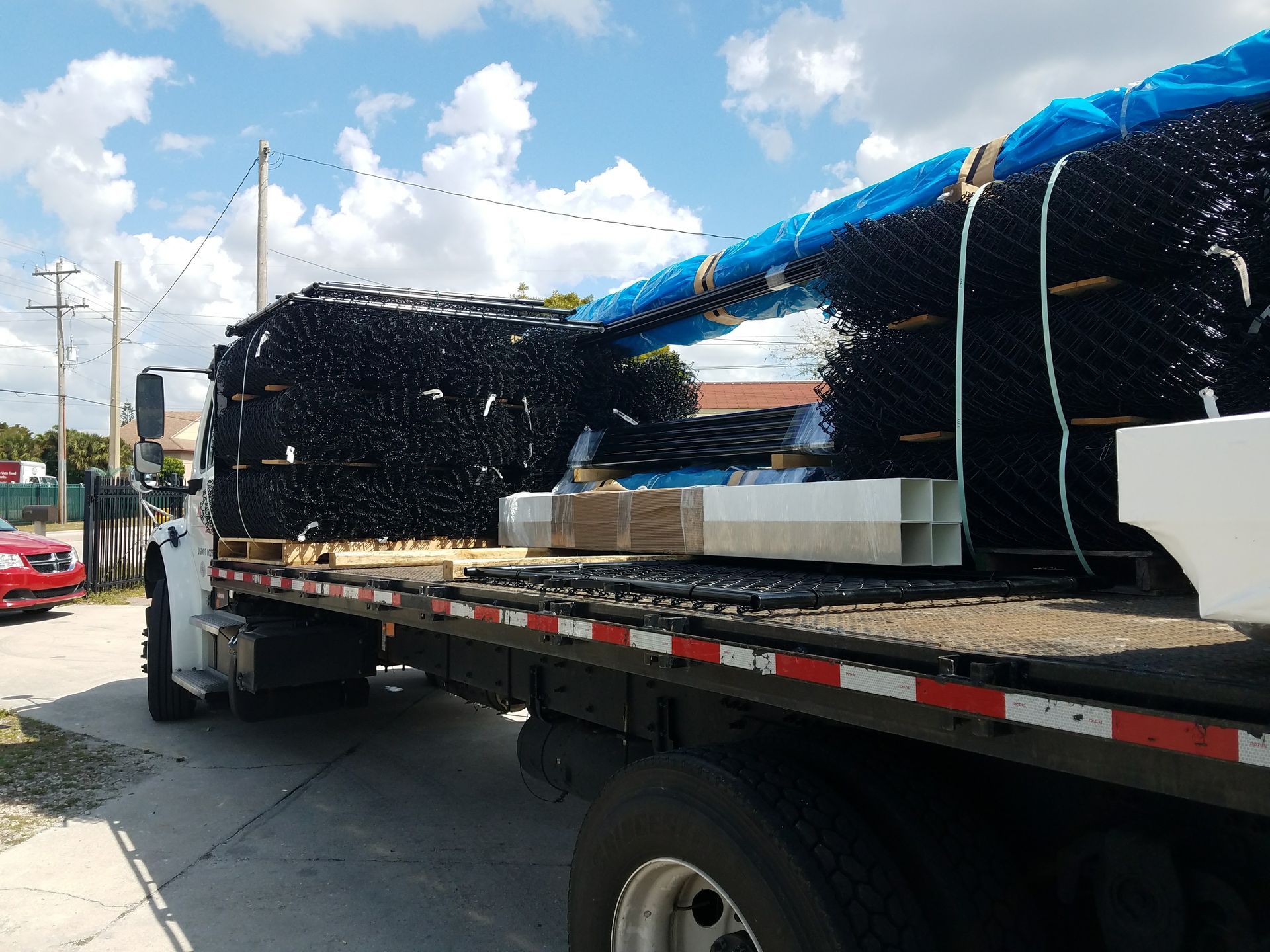 A tow truck is carrying a large stack of scaffolding.