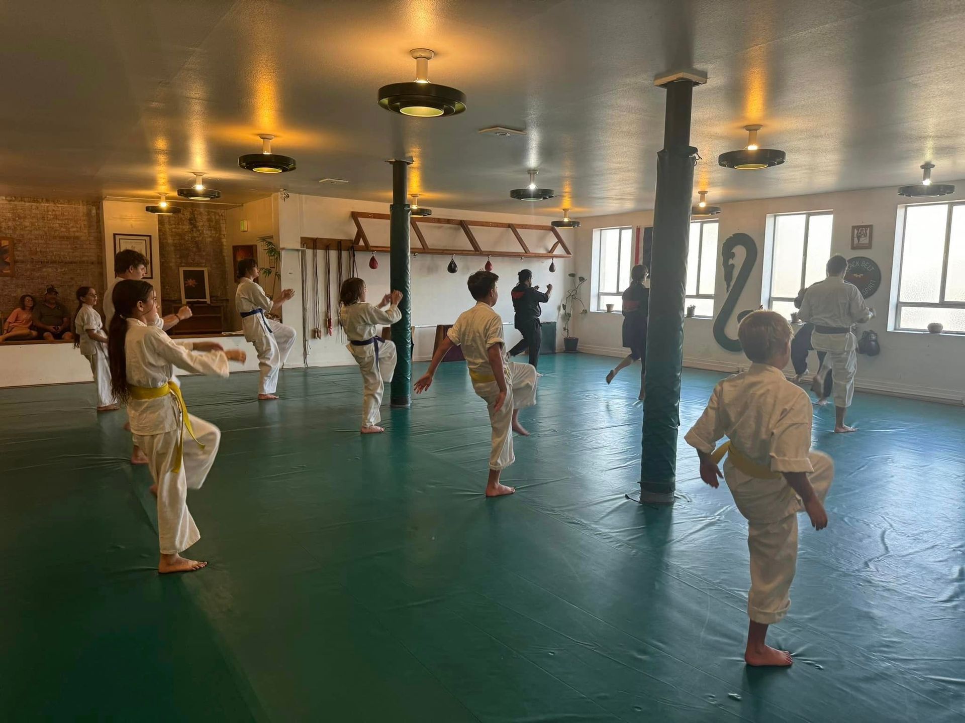 A person is holding a sparkler in their hand in the dark.