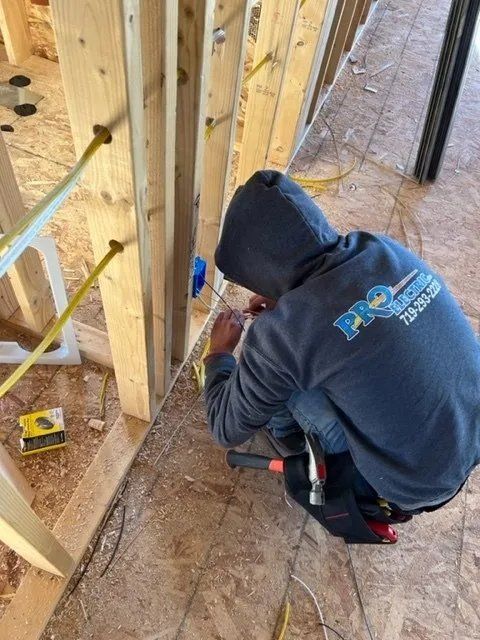 man installing electrical wiring