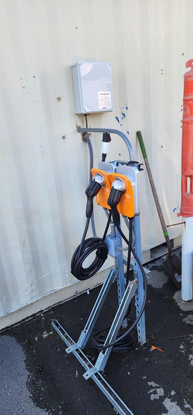 Commercial ChargePoint electric vehicle dual charging station mounted outdoors