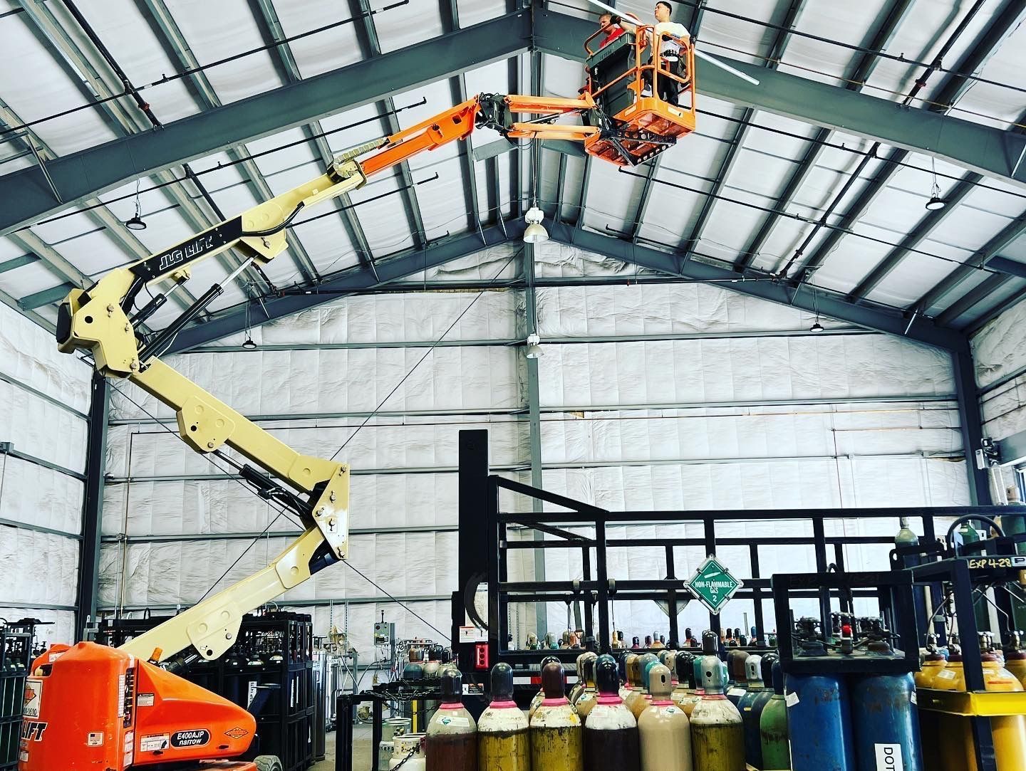 technician in a lift in a warehouse
