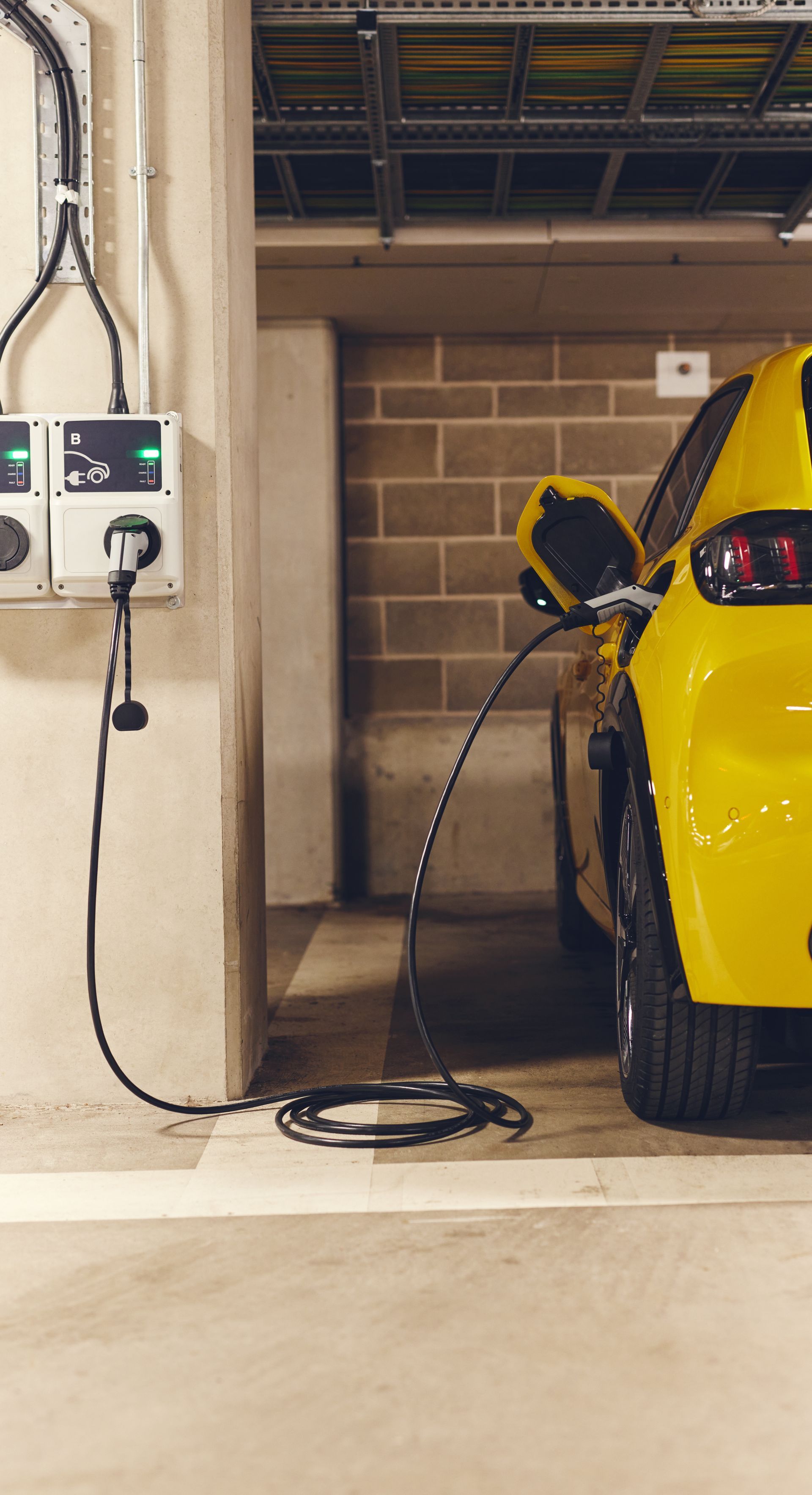 electric vehicle charger charging a yellow car