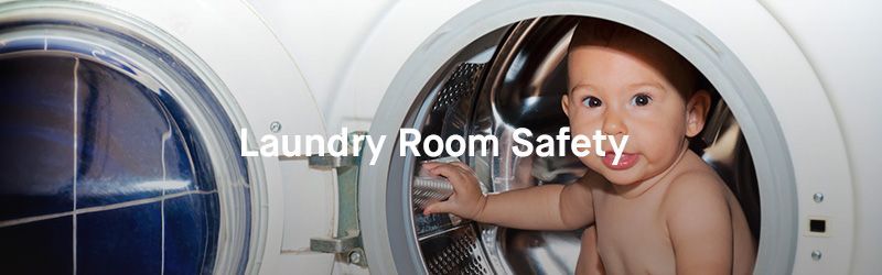 A baby is sitting in the door of a washing machine.