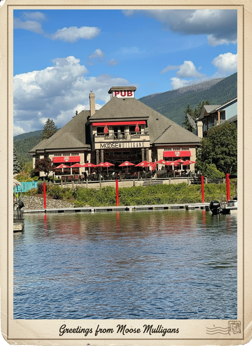 Moose Mulligans Pub on lakefront with red awnings, water reflection, mountains in background, and blue sky.