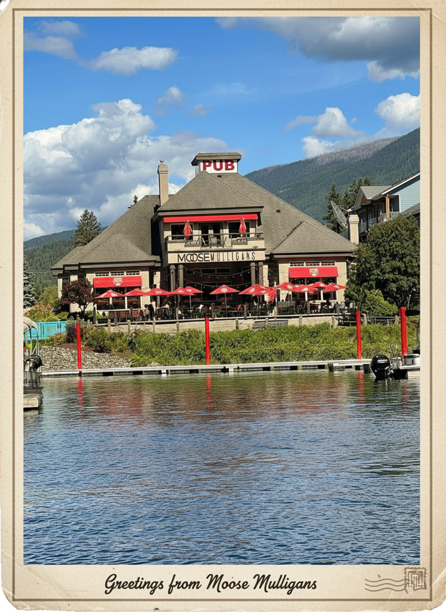 Moose Mulligans Pub on lakefront with red awnings, water reflection, mountains in background, and blue sky.