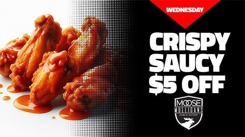 Close-up of saucy chicken wings with text 