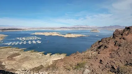 A large body of water surrounded by rocks and mountains.