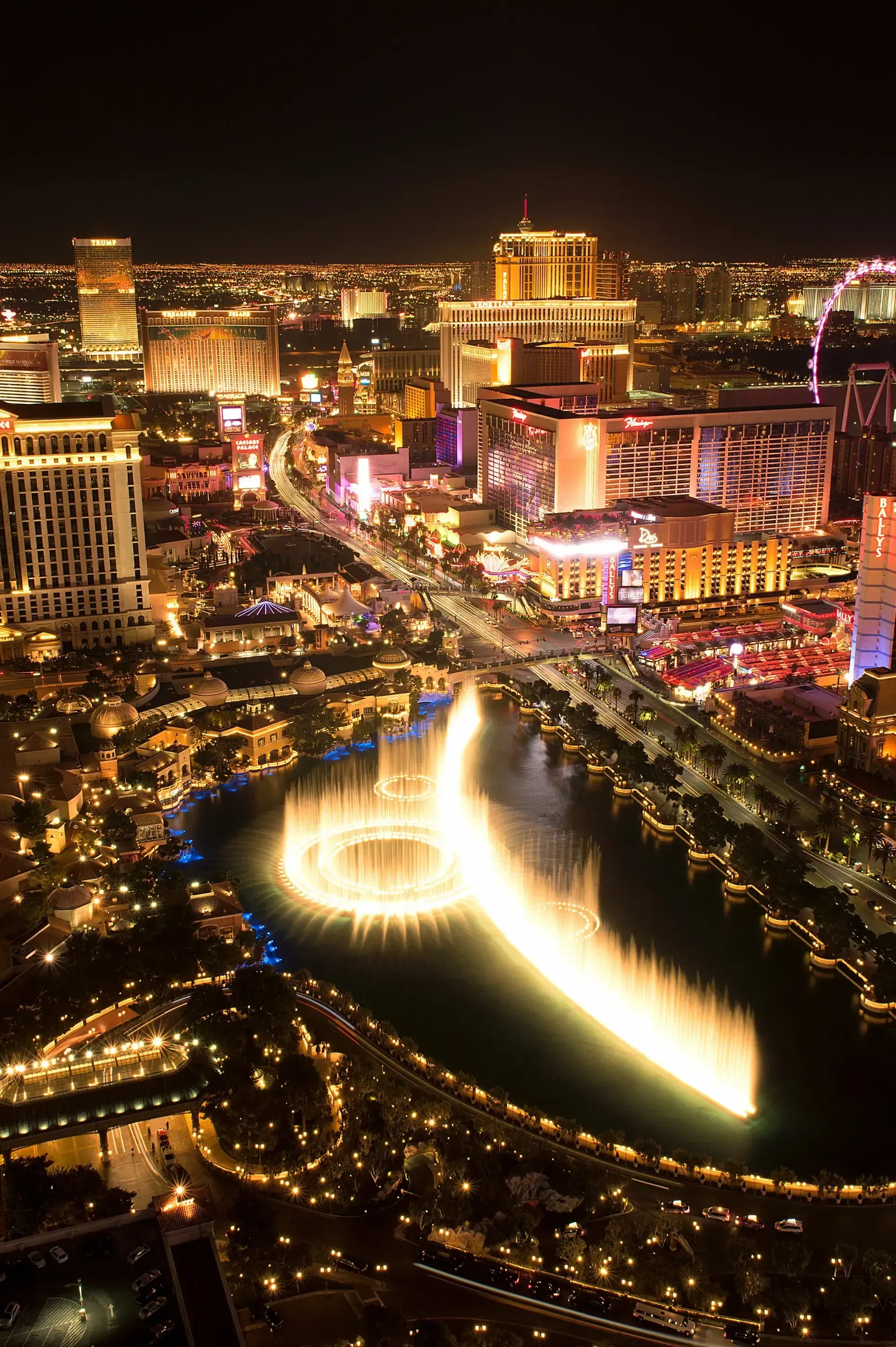 Sell My House Fast - An aerial view of las vegas at night with a fountain in the middle of the city