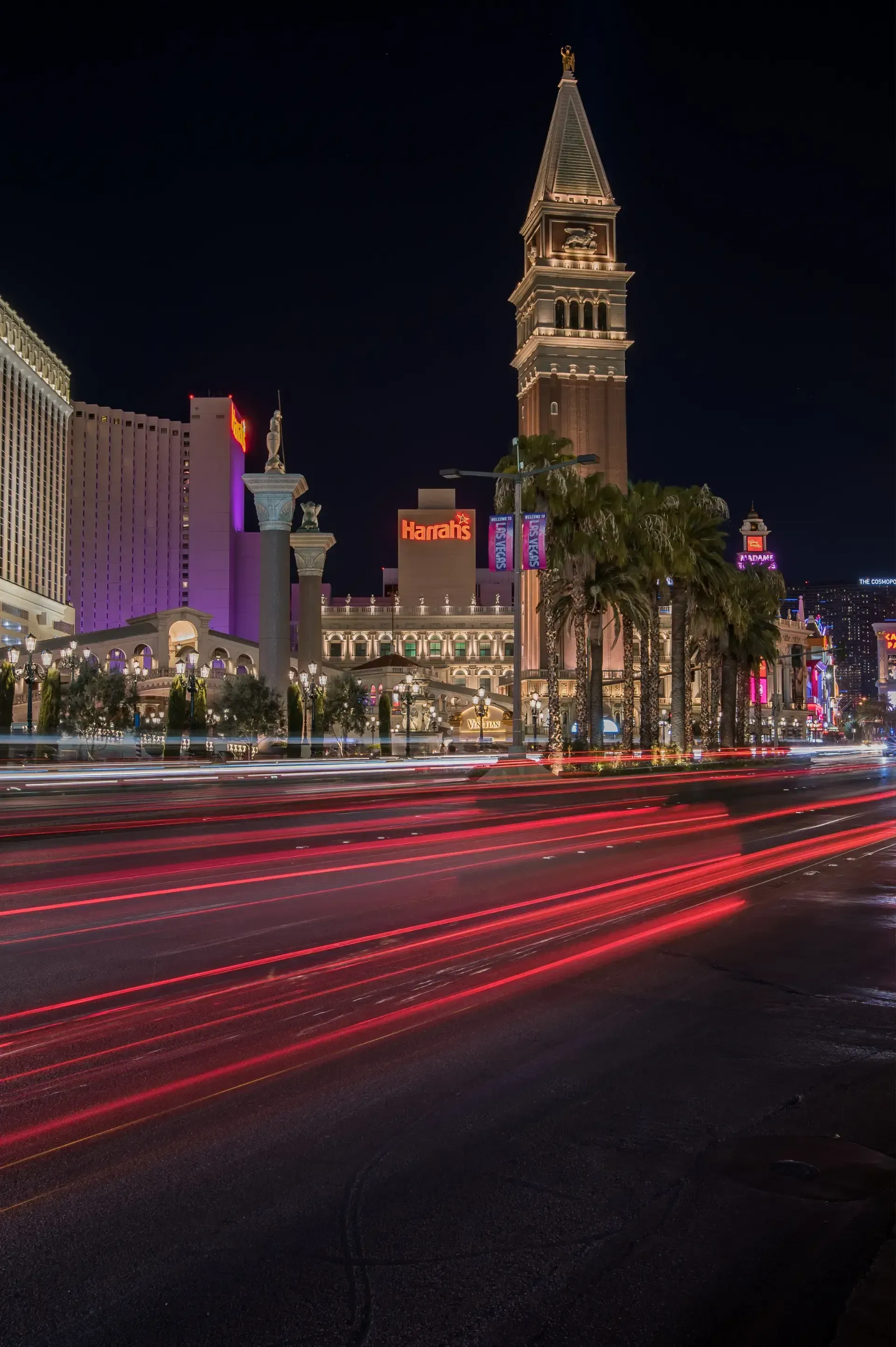 Sell My House Fast - A long exposure photo of a city street at night with a clock tower in the background.