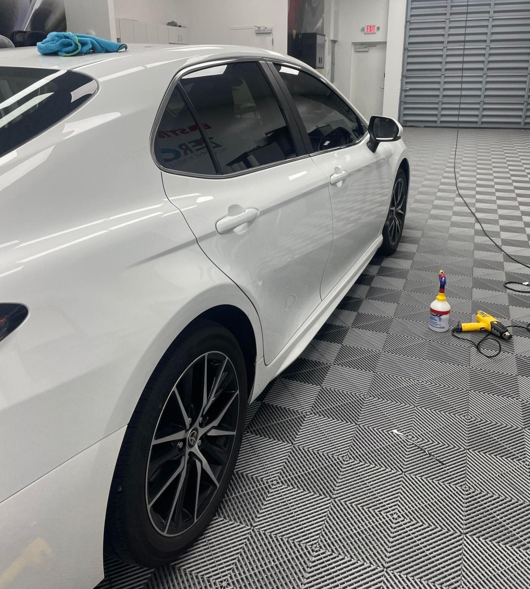 Car with freshly replaced window tint showing a smooth, bubble-free finish