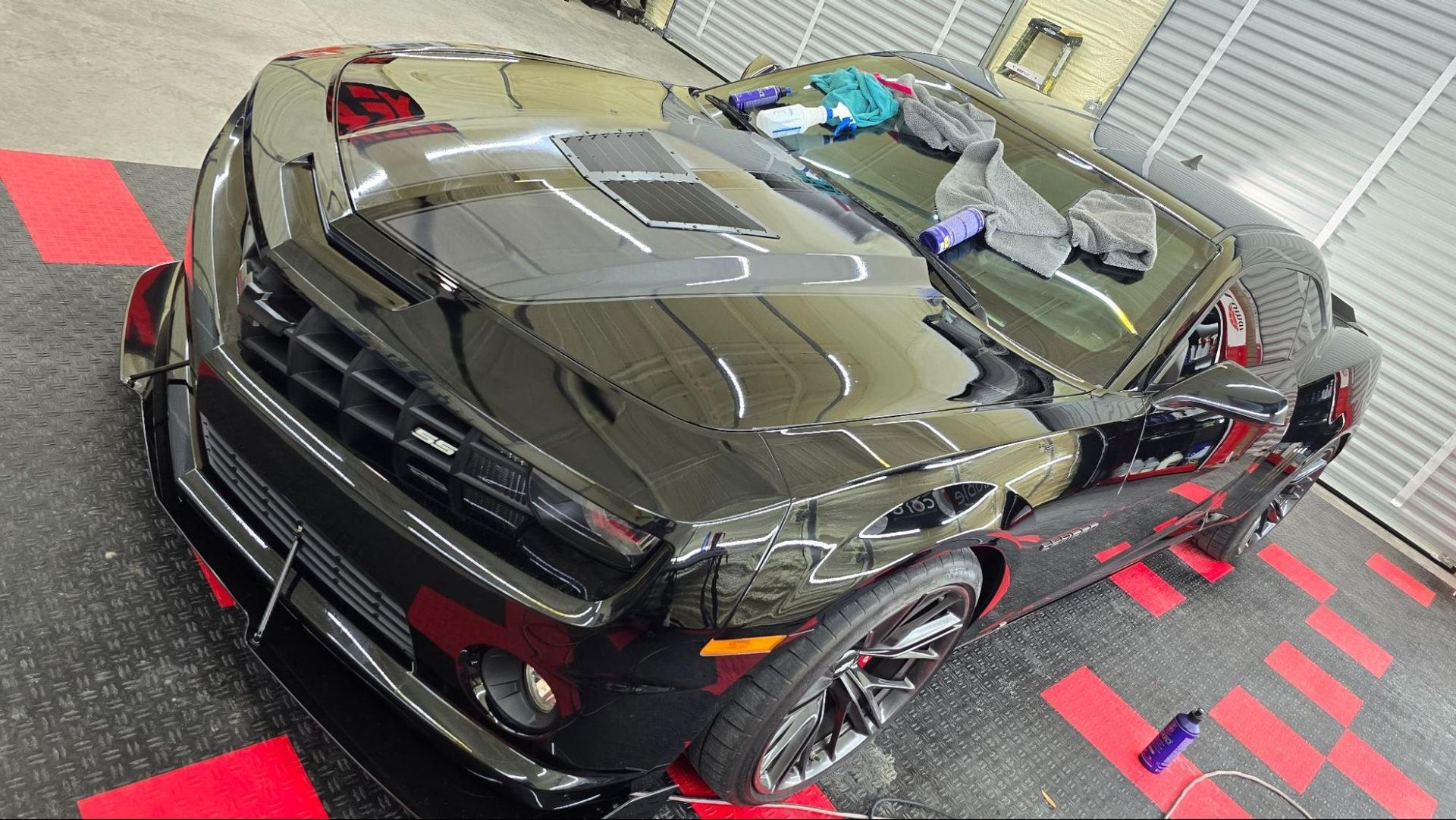 Glossy black car after professional ceramic coating application