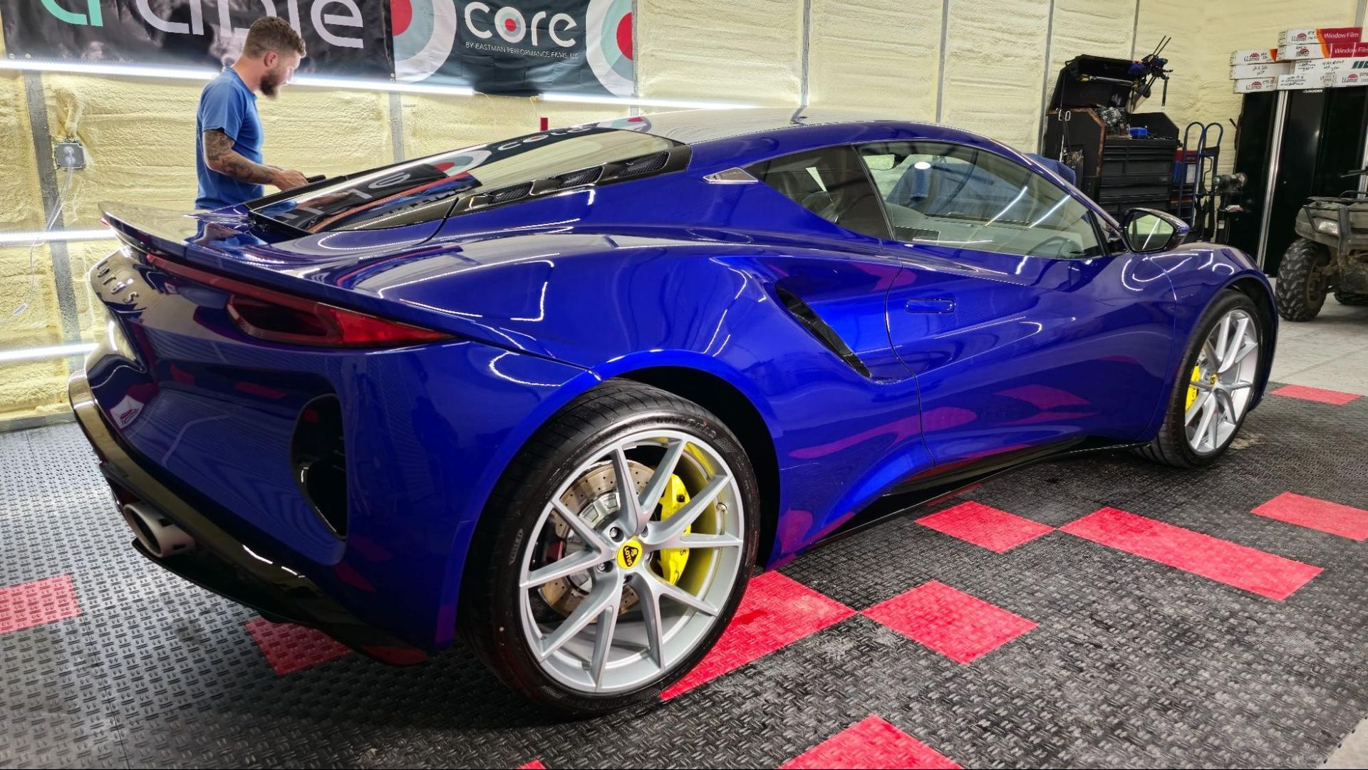 Mirror-like shine on blue car after ceramic coating treatment.