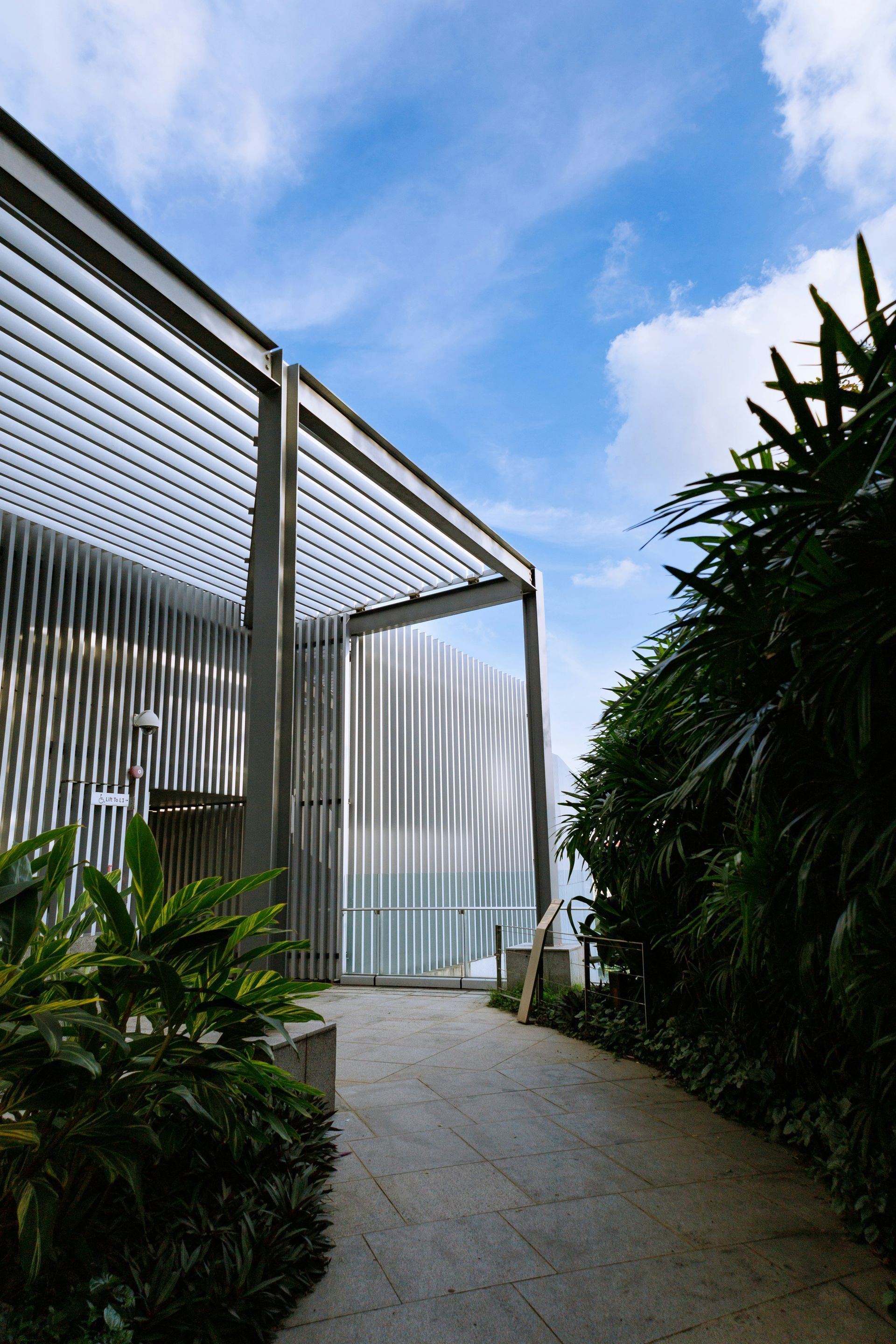 Modern kitchen with white cabinets, island, and stools, featuring a minimalist design.