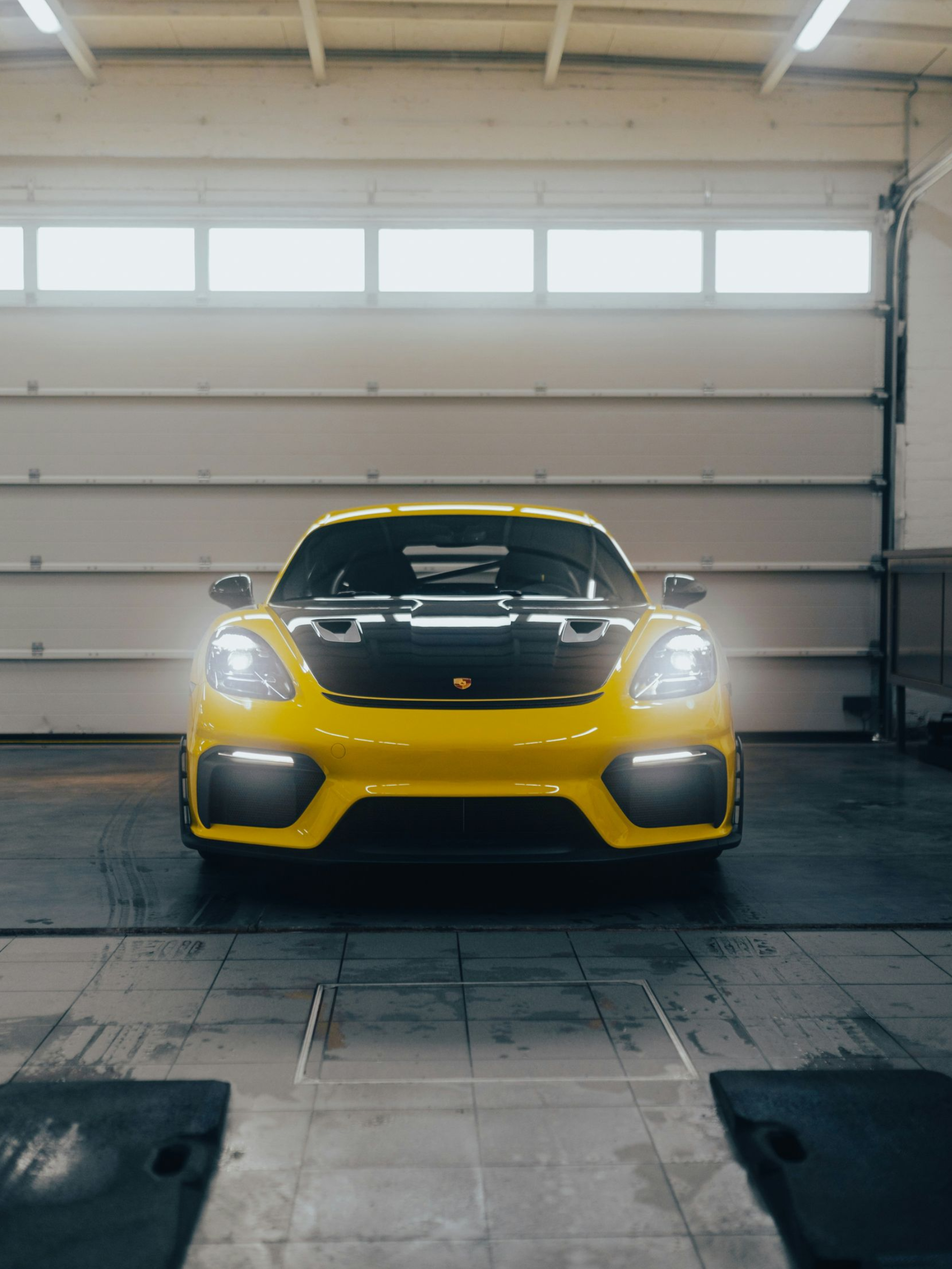 Blue Lamborghini Urus SUV parked on a cobblestone street near a multi-story building.