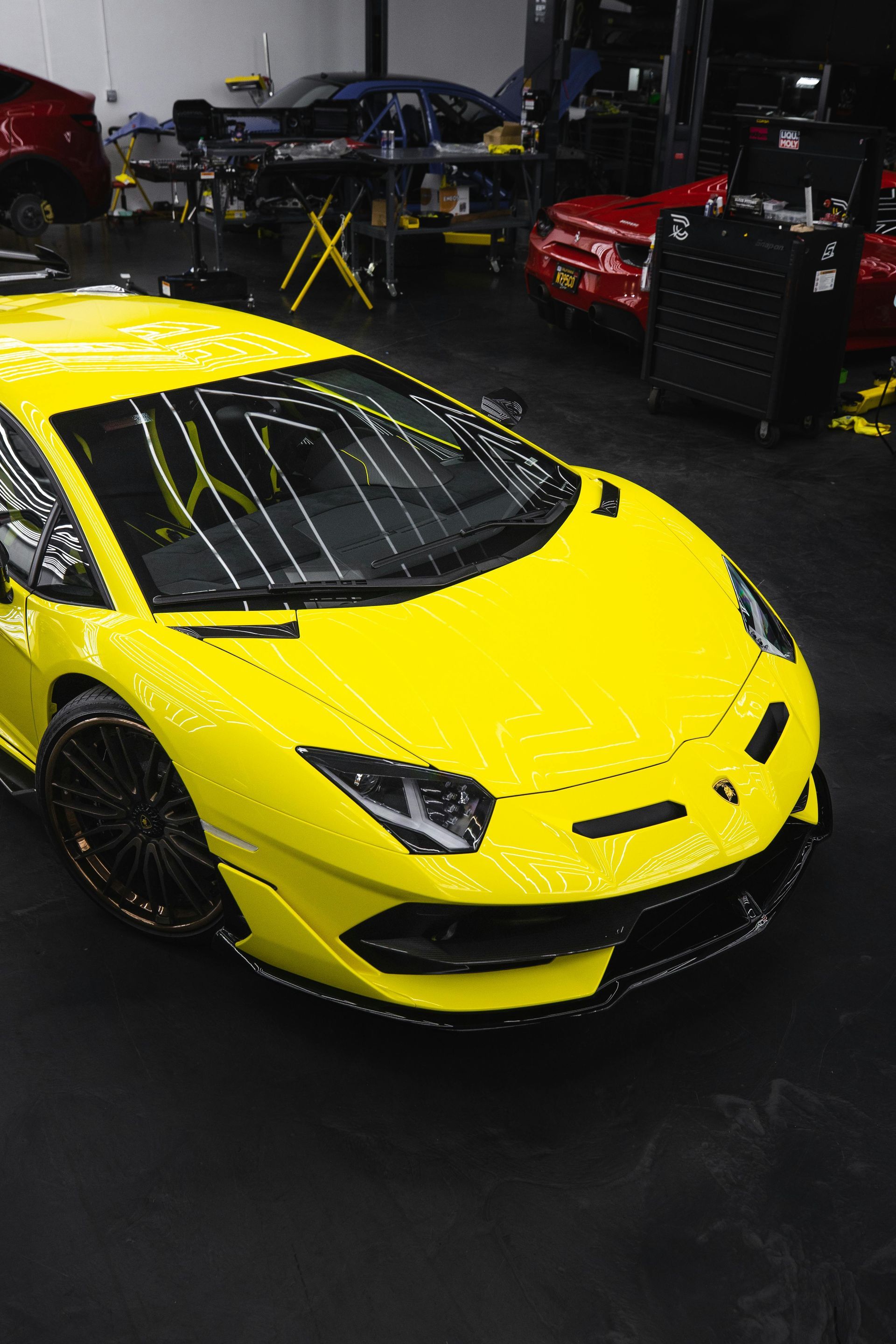 Yellow Lamborghini in a garage.