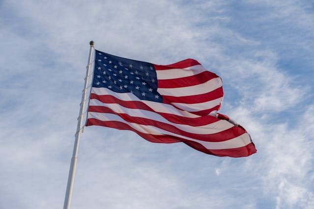 A waving American flag creates a patriotic tribute for cremation services Burnsville, MN