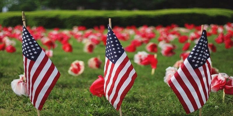 American flags placed at a memorial site representing veteran honors and respectful Burnsville, MN cremations services