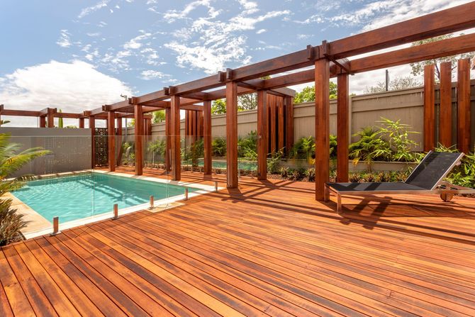 Man building a wooden deck frame.