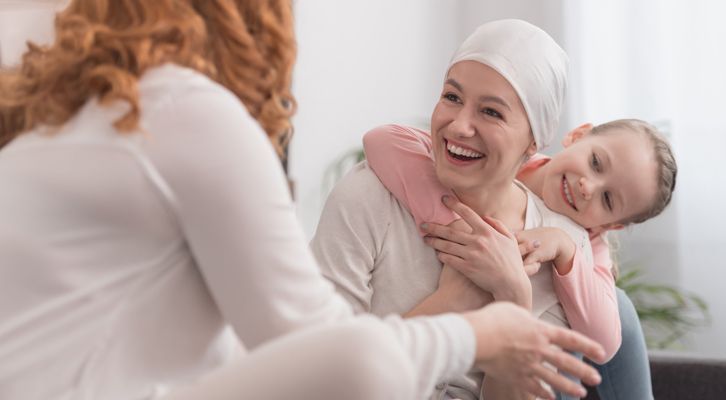 A Woman with Cancer surrounded by family at Acupuncture for Cancer Support NYC