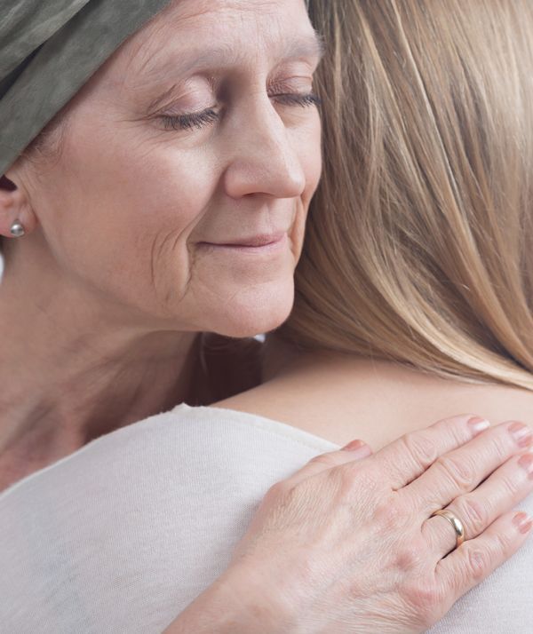 A Woman Huggubg her Daughter Getting Chemotherapy. Acupuncture as a Supportive Therapy for Cancer Patients.