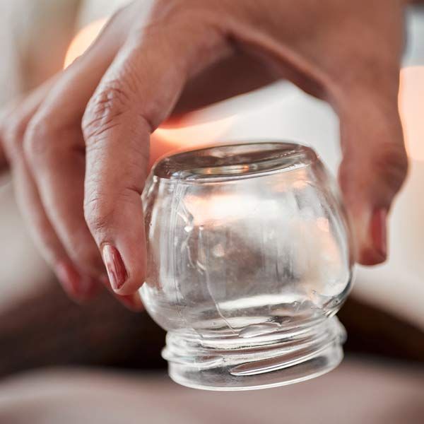 Close up of a glass cup used in acupuncture cupping treatments