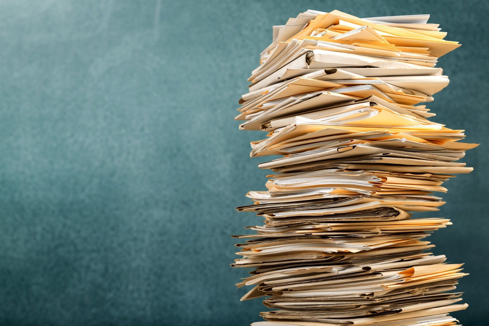 Tax Documents stacked on table for bookkeeping