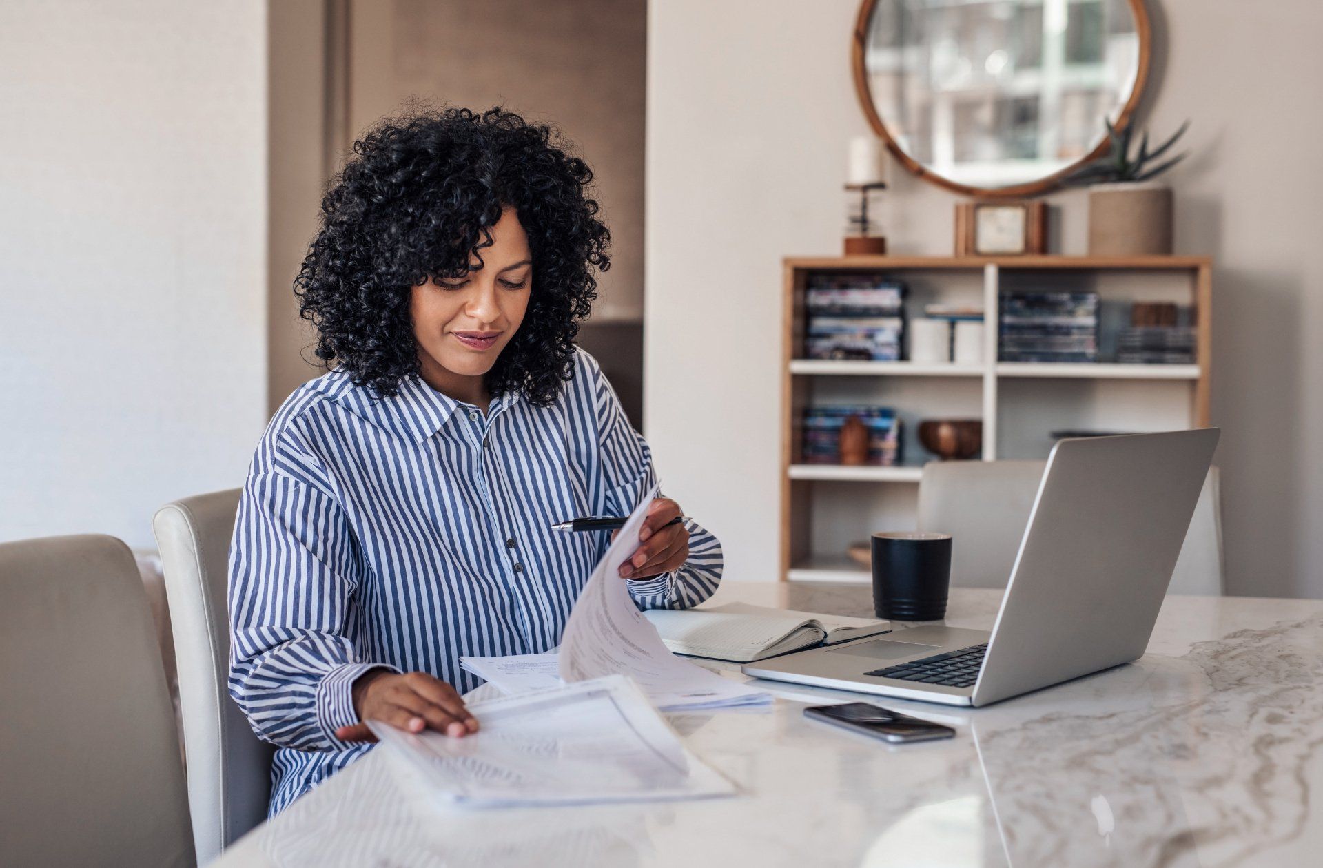 self-employed woman sitting at computer working on tax deductions