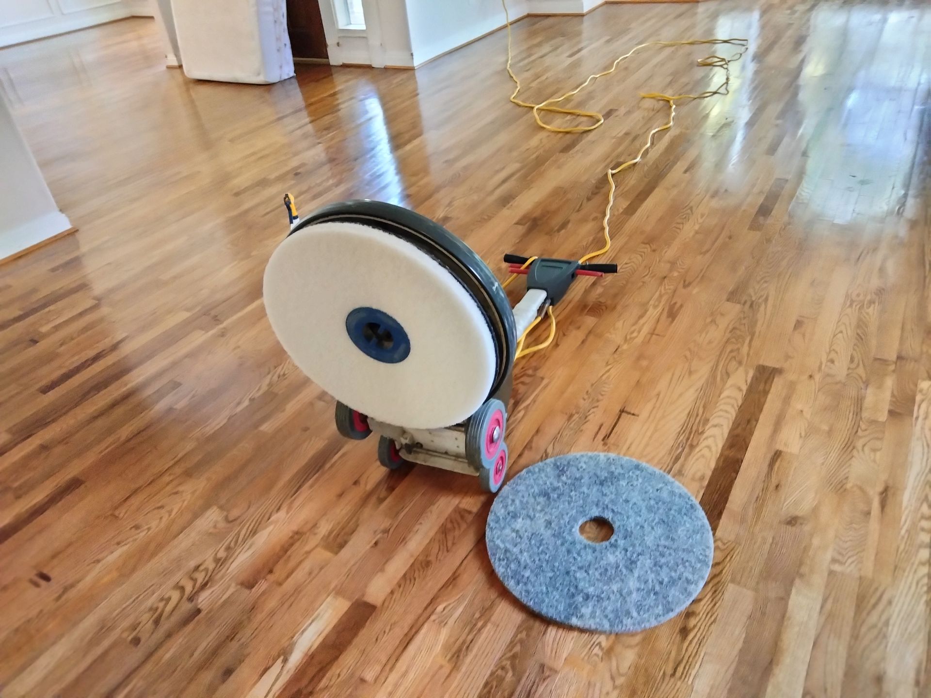 A machine is sitting on a wooden floor in a room.