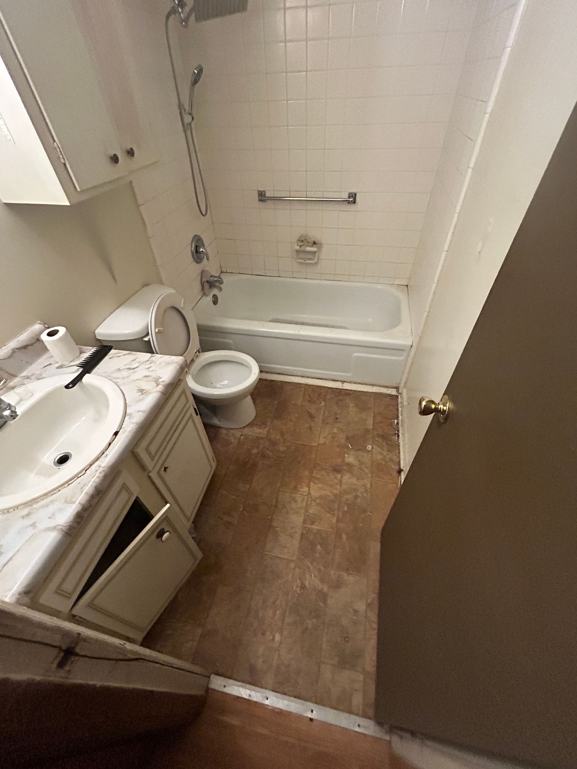 A bathroom with a sink , toilet , bathtub and shower.