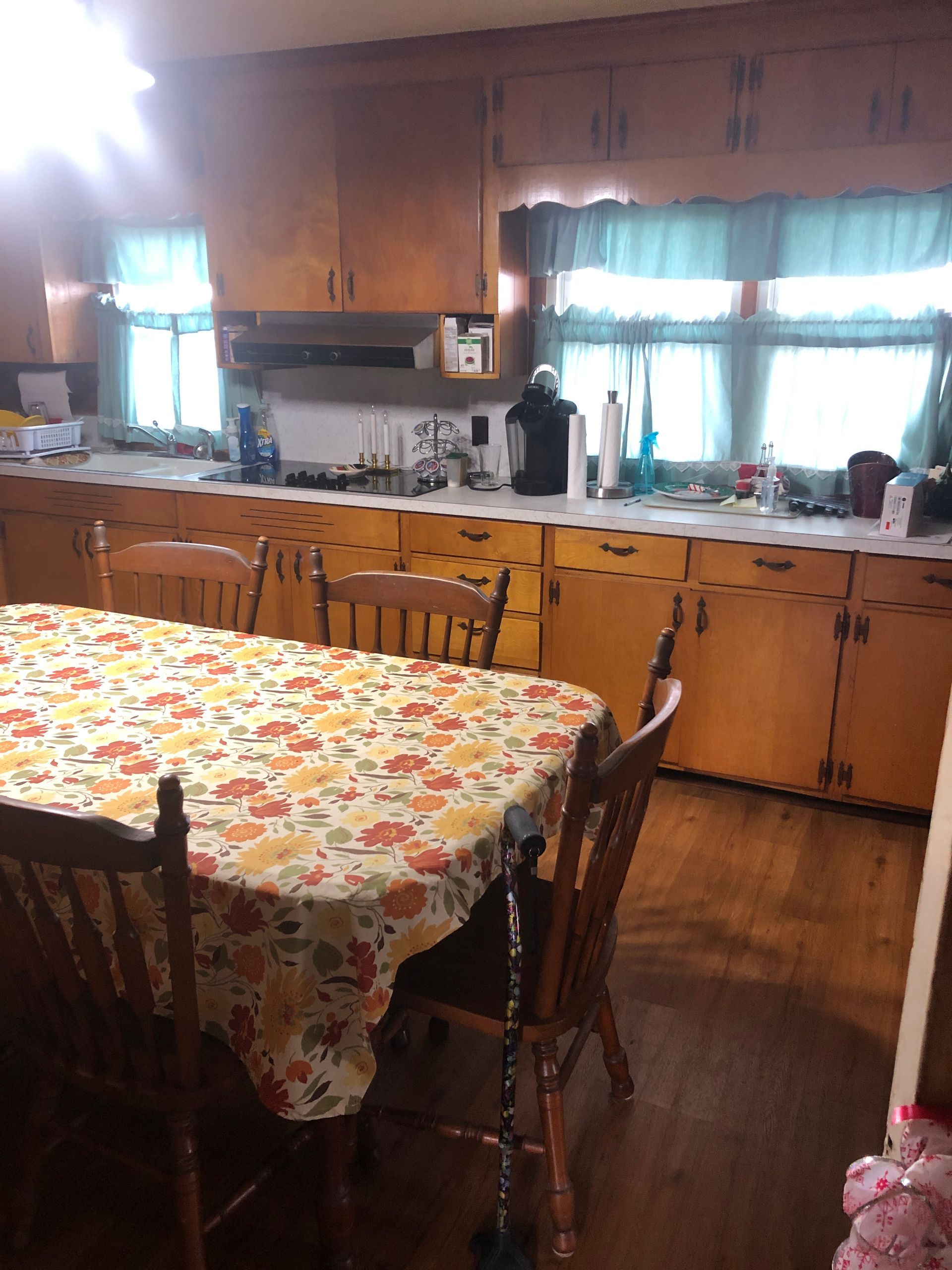 A kitchen with a table and chairs in it