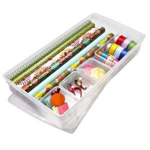 A clear plastic box filled with wrapping paper and ribbons A clear plastic box filled with wrapping paper and ribbons
