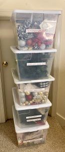 A stack of clear plastic bins filled with christmas decorations. A stack of clear plastic bins filled with christmas decorations.