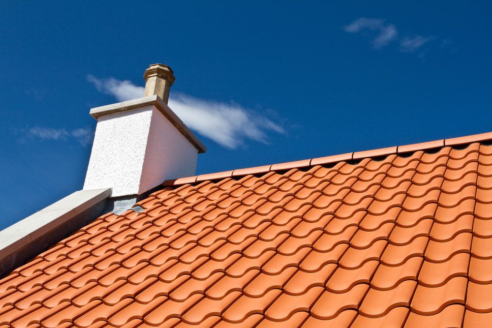 Orange Roof Tiles with Chimney — Goonellabah Roof Tilers In Kyogle, NSW