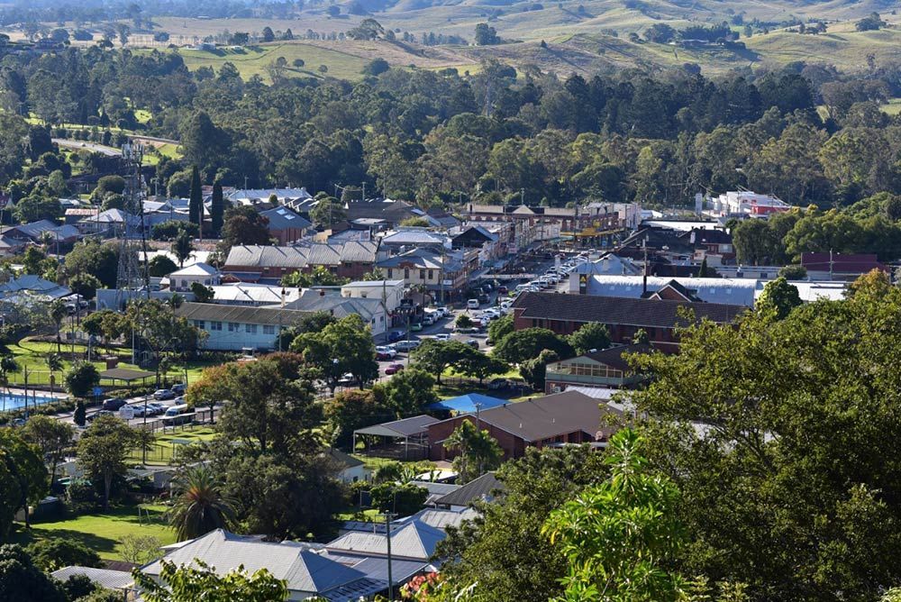An Aerial View of a Small Town Surrounded by Trees — Goonellabah Roof Tilers In Kyogle, NSW